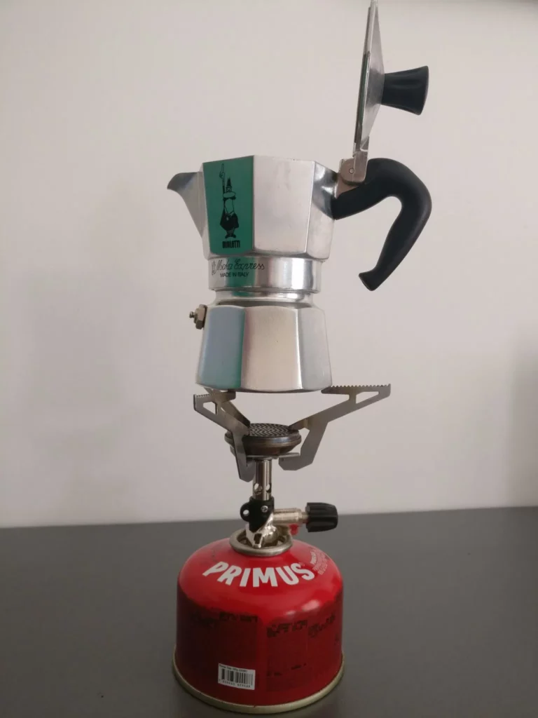 Succeeding in making coffee with a moka pot: the secrets revealed : A Moka pot on a gas stove with the lid open.